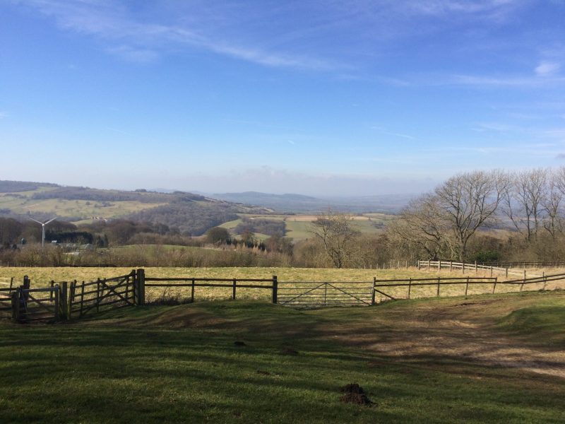 An old wooden fence in a beautiful mountain landscape under the blue sky